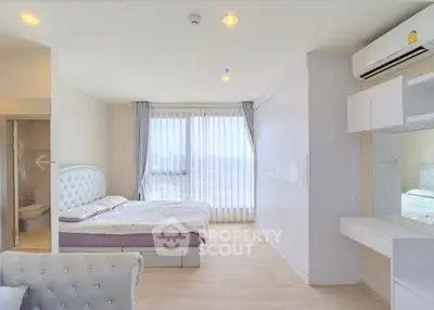 Spacious modern bedroom with elegant decor and natural light