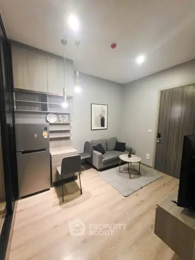 Modern living room with cozy sofa and stylish decor in a compact apartment.