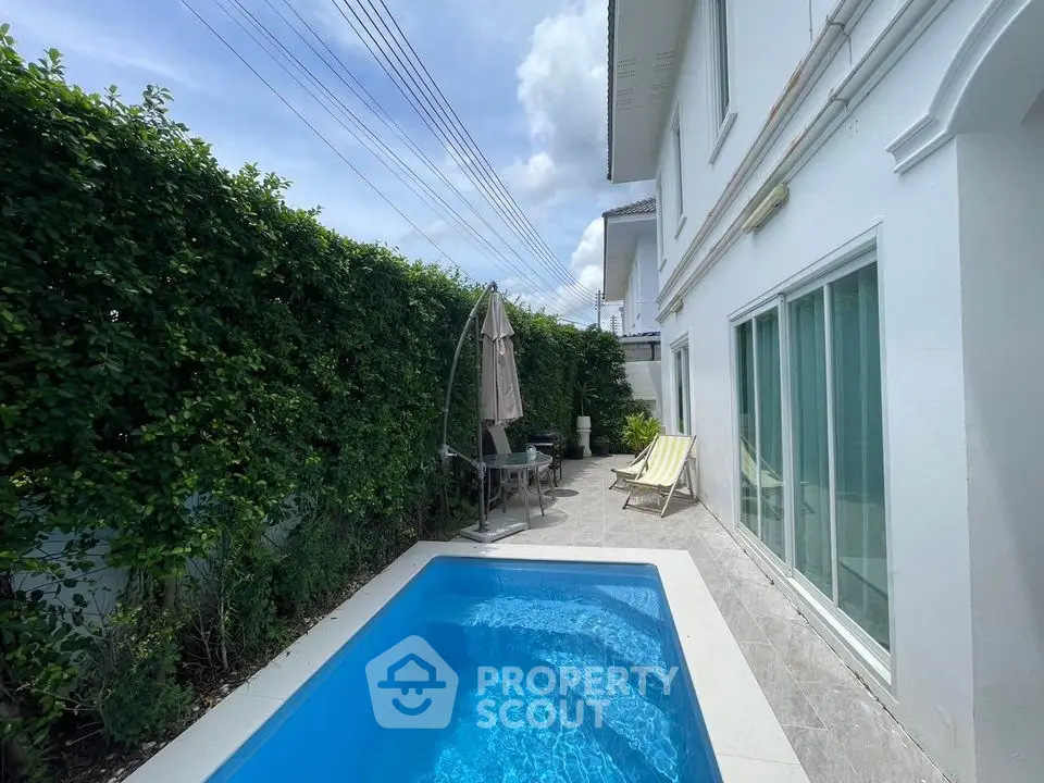 Charming backyard with private pool and lush greenery for serene relaxation.