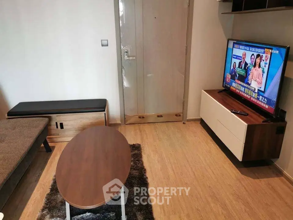 Modern living room with stylish furniture and flat-screen TV, perfect for cozy relaxation.