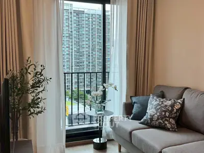 Cozy living room with a view of cityscape through large window.