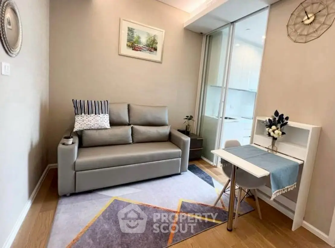Cozy living room with modern sofa and stylish decor in a compact apartment.