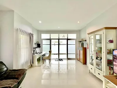 Spacious living room with modern decor and large windows for natural light.