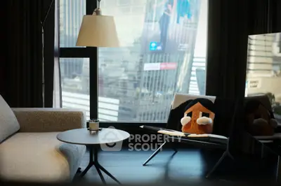 Modern living room with city view, stylish furniture, and large windows in urban apartment