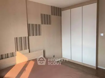 Modern bedroom with stylish wall design and built-in wardrobe
