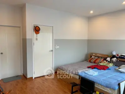 Cozy bedroom with wooden flooring and modern decor