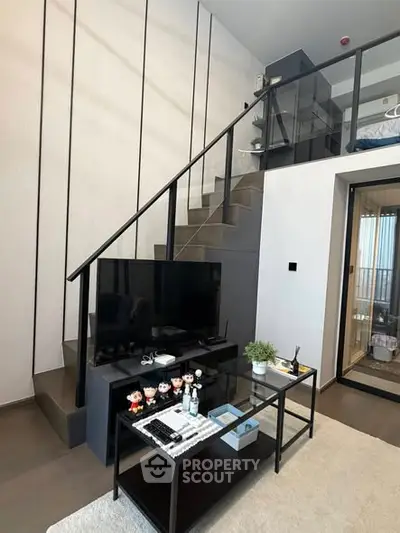 Modern duplex living room with stylish staircase and sleek decor