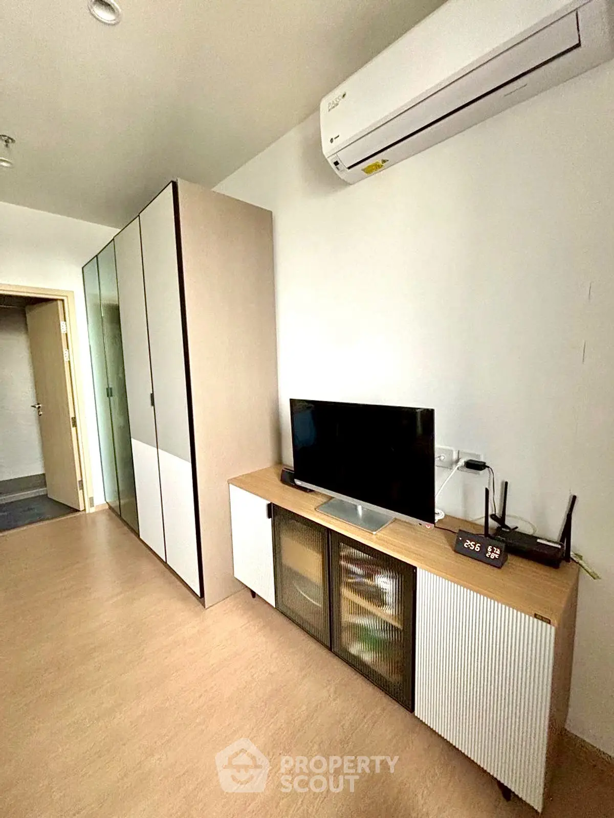 Modern living room with sleek furniture and air conditioning unit, perfect for urban living.