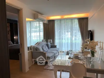 Elegant living room with dining area, featuring large windows and stylish decor, perfect for modern living.