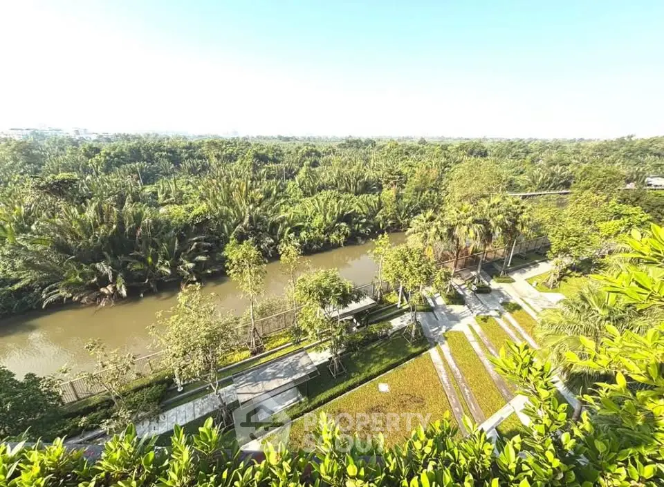 Stunning river view from a lush green balcony in a serene residential area.