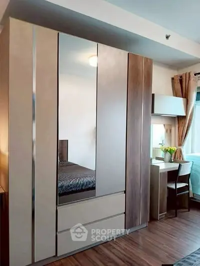 Modern bedroom with sleek wardrobe and cozy study nook