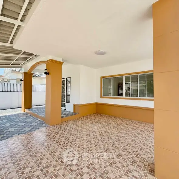 Spacious covered parking area with tiled flooring and modern design.