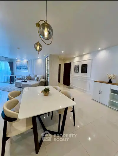 Elegant modern living room with stylish dining area and contemporary lighting