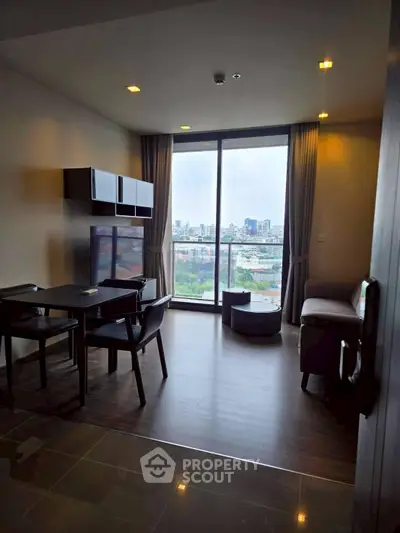 Modern living room with city view, featuring sleek furniture and large windows for natural light.