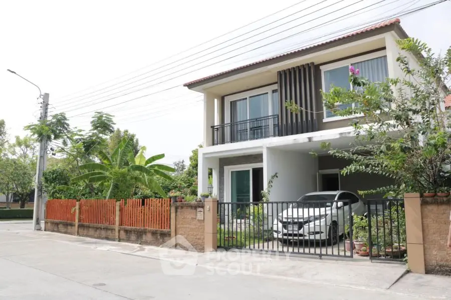 Charming two-story house with carport and lush garden in a serene neighborhood.