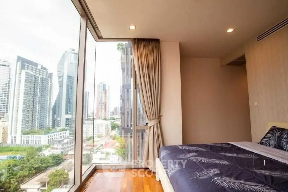 Luxurious bedroom with floor-to-ceiling windows offering stunning city views in a modern high-rise apartment.
