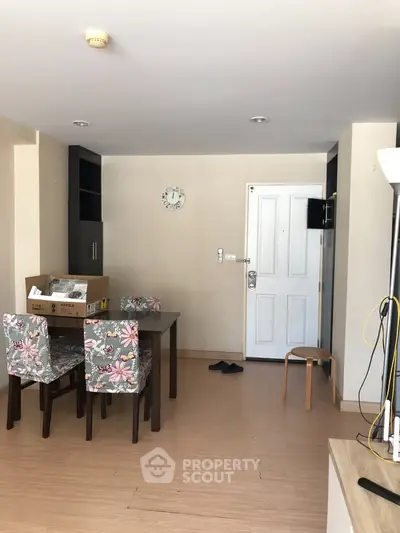 Spacious living room with floral chairs and modern decor, perfect for cozy gatherings.