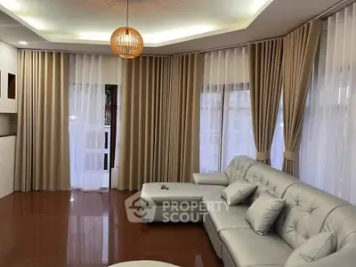 Spacious living room with elegant curtains and modern furniture