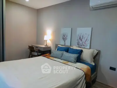 Cozy bedroom with modern decor and study area, perfect for relaxation and productivity.