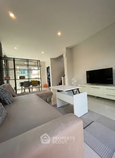 Modern living room with stylish furniture and open dining area