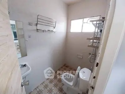 Compact bathroom with modern fixtures and tiled floor