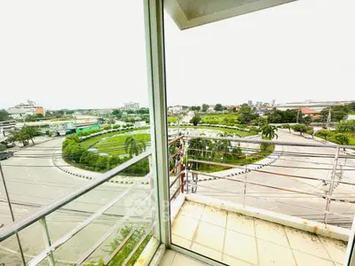 Stunning balcony view overlooking lush green roundabout in urban setting
