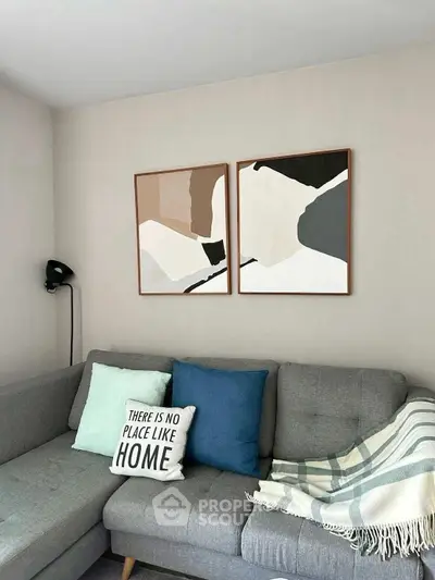 Stylish living room with modern art and cozy gray sofa