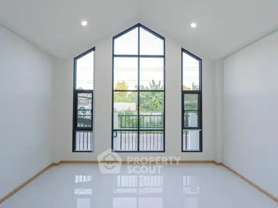 Spacious room with large windows offering abundant natural light and a modern design.