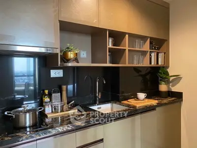 Modern kitchen with sleek cabinetry and marble countertops, featuring a scenic view from the window.