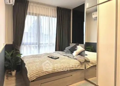 Modern bedroom with cozy decor and large window offering city view