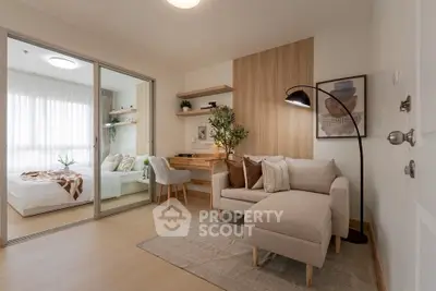 Modern living room with cozy sofa and stylish decor adjacent to a bright bedroom.