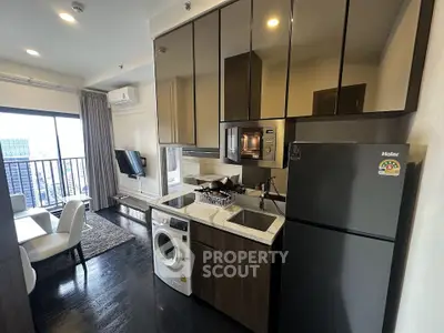 Modern kitchen with sleek appliances and city view, featuring washing machine and open layout.
