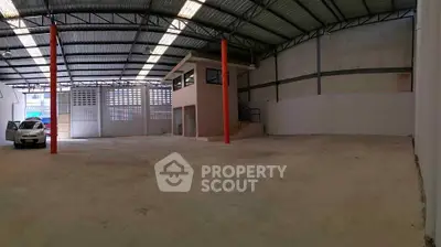 Spacious industrial warehouse with high ceilings and office space, ideal for storage or manufacturing.