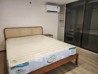 Modern bedroom with new mattress and built-in wardrobe