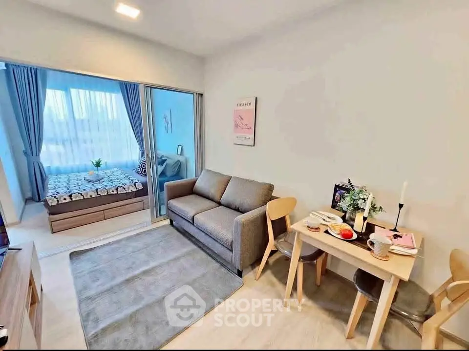 Cozy living room with dining area and view into a stylish bedroom