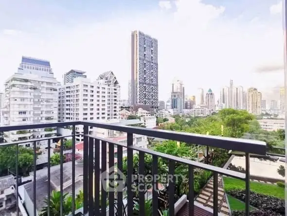 Stunning cityscape view from a modern balcony overlooking skyscrapers and lush greenery.