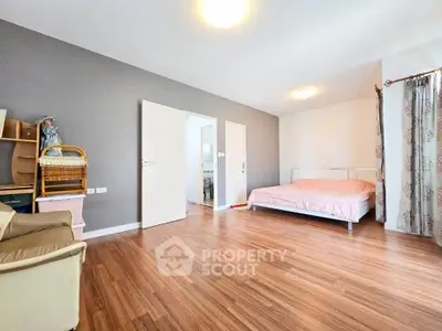 Spacious bedroom with wooden flooring and modern decor