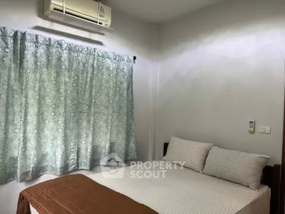 Cozy bedroom with air conditioning and elegant curtains, perfect for restful nights.