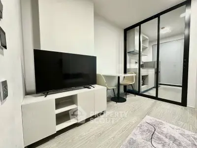 Modern living room with sleek TV stand and open kitchen layout