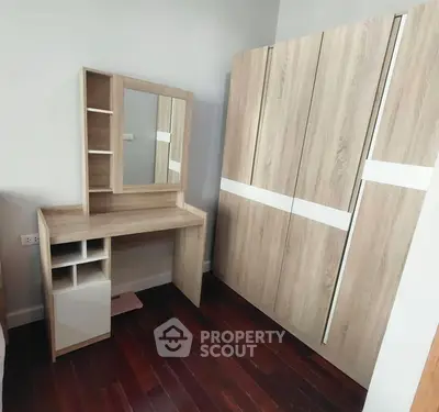 Modern bedroom with stylish wooden wardrobe and vanity set