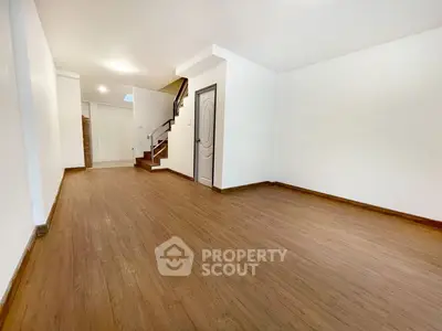 Spacious empty living room with wooden flooring and modern design