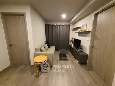 Modern living room with cozy sofa and sleek TV unit in stylish apartment.