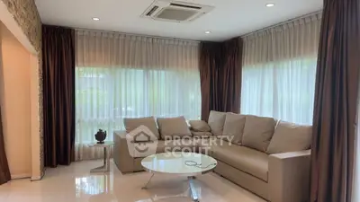 Spacious living room with modern sofa and large windows for natural light