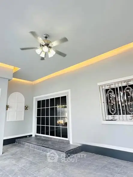 Modern exterior with ceiling fan and stylish window grill