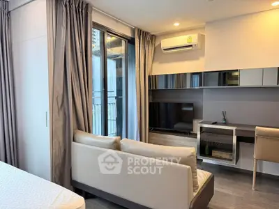 Modern living room with sleek furniture and large windows in a stylish apartment.