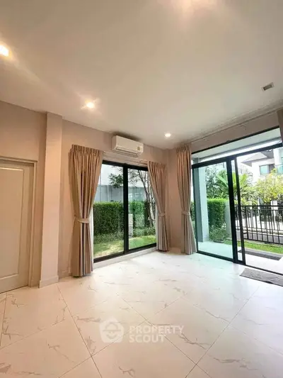 Spacious living room with large windows and garden view in modern home