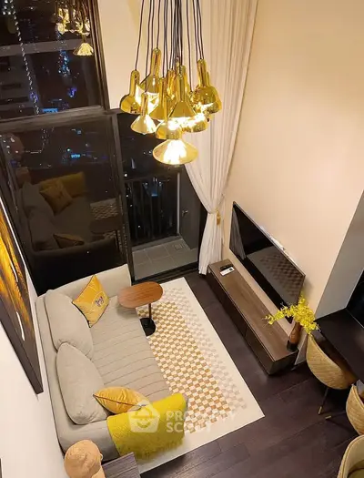 Stylish living room with modern lighting and cozy decor overlooking city view.