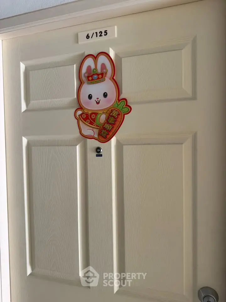 Charming apartment door with festive rabbit decoration, perfect for welcoming guests in style.