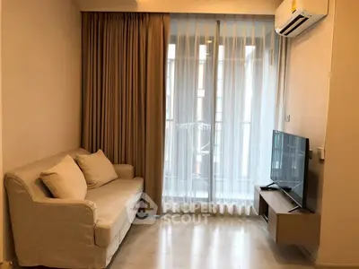 Cozy living room with modern sofa and TV, featuring floor-to-ceiling windows and elegant curtains.