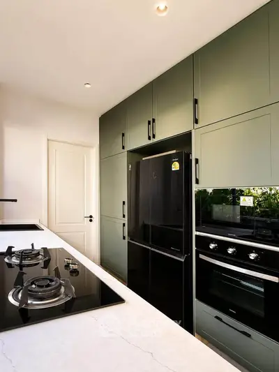 Modern kitchen with sleek appliances and gas stove in stylish home